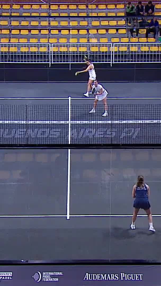 Navarro follows her smash up with a volley to the open corner