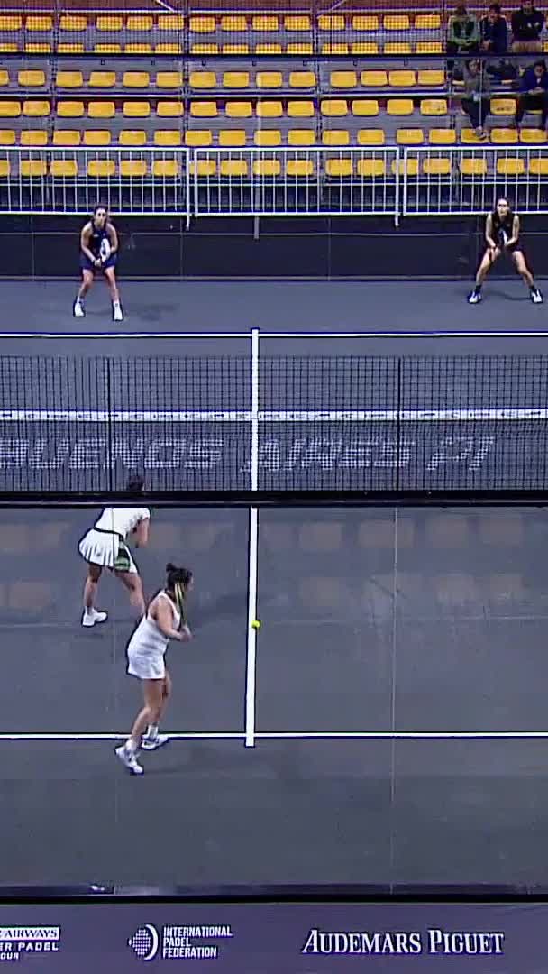 Saiz hits a sharp backhand volley to the fence